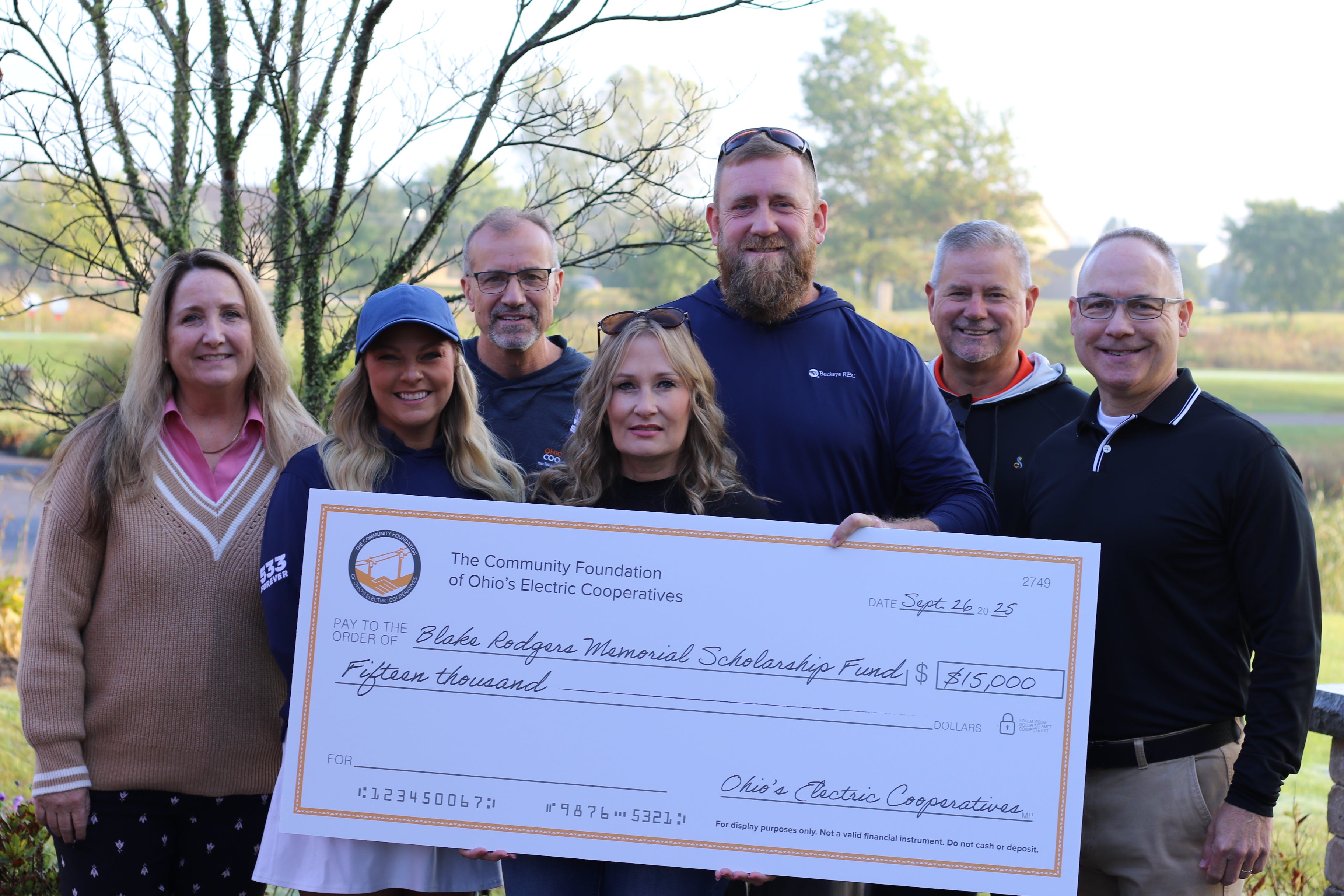A group of people posing during a check presentation
