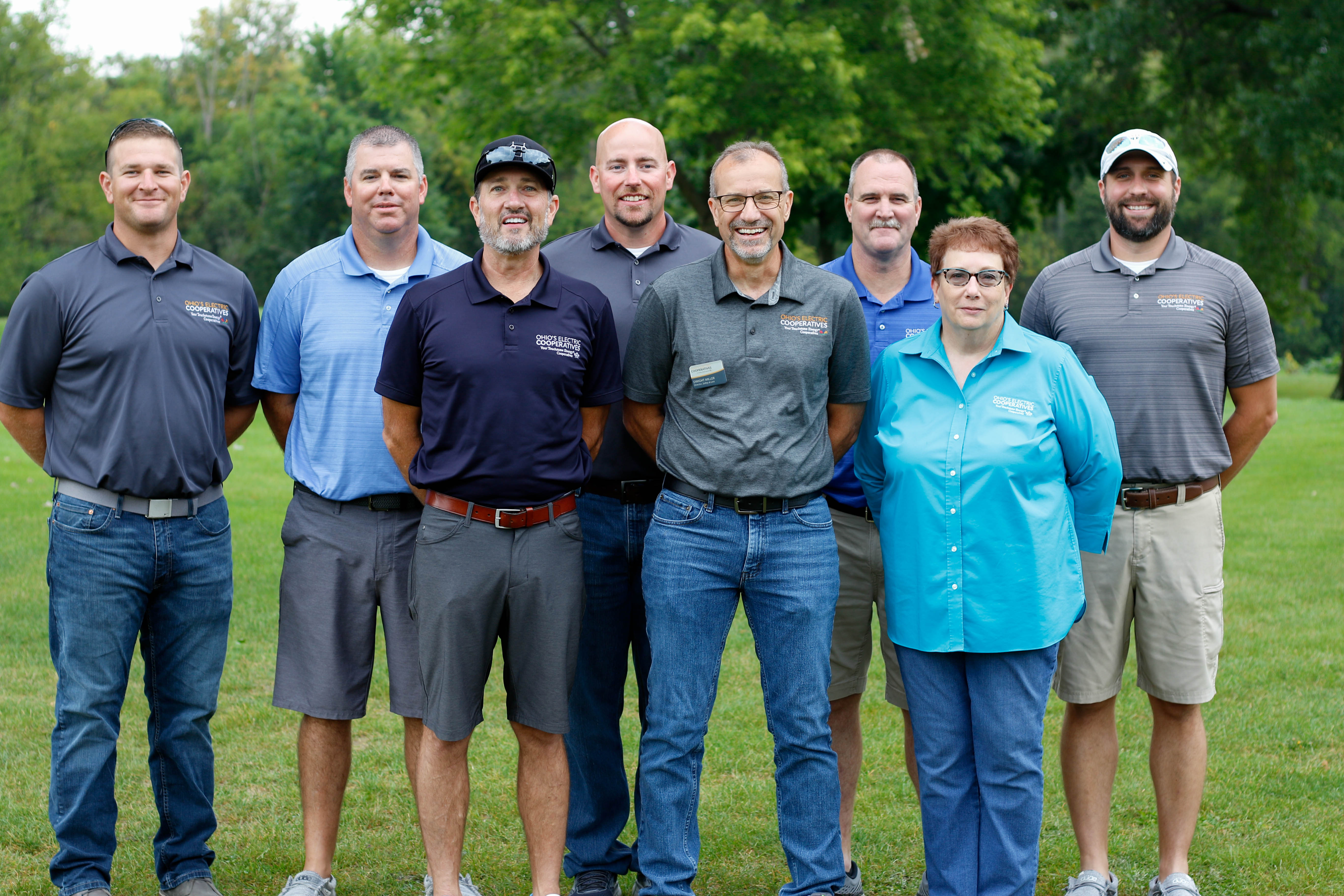 A group of people posing at a golf course