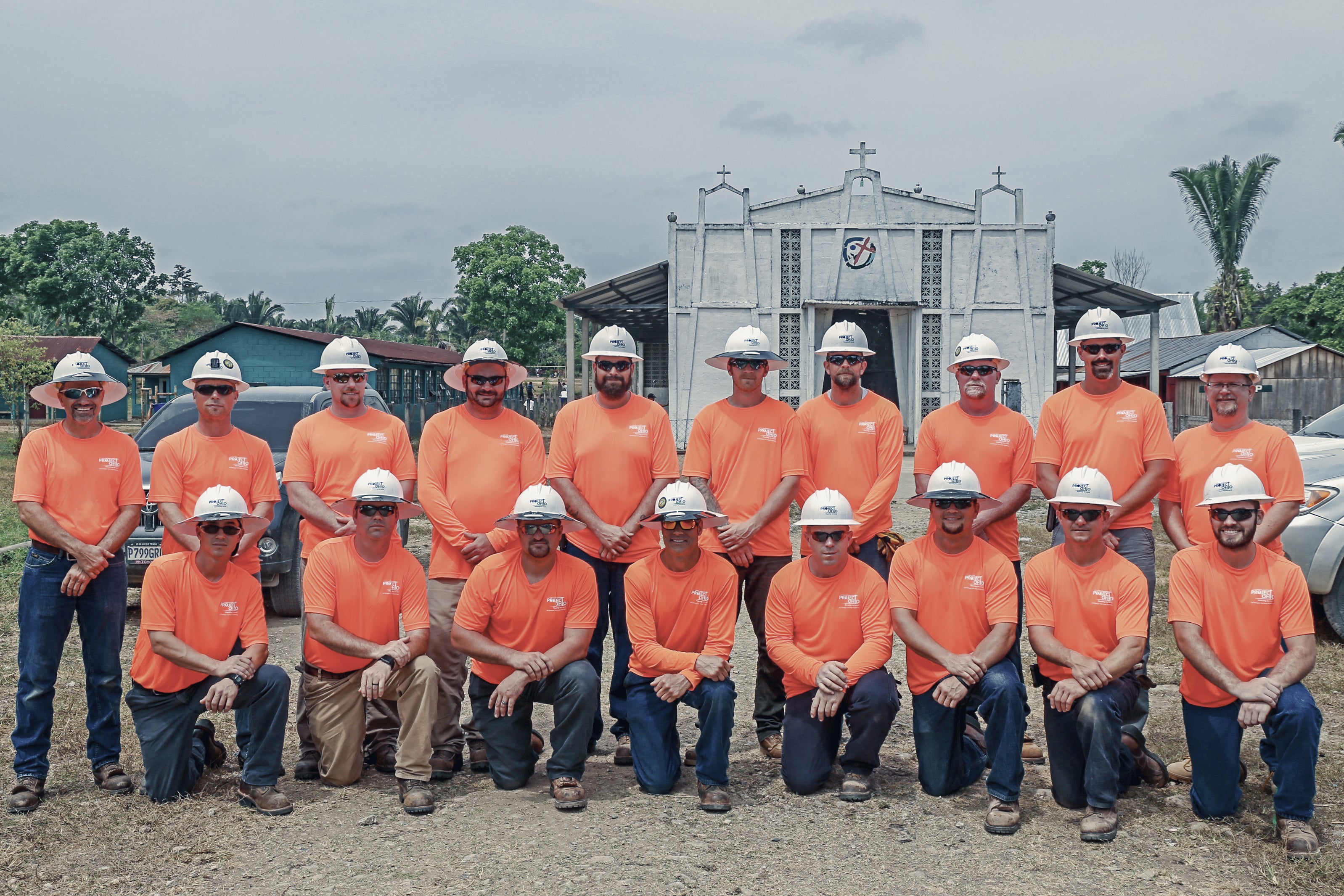 A group of linemen posing in hard hars