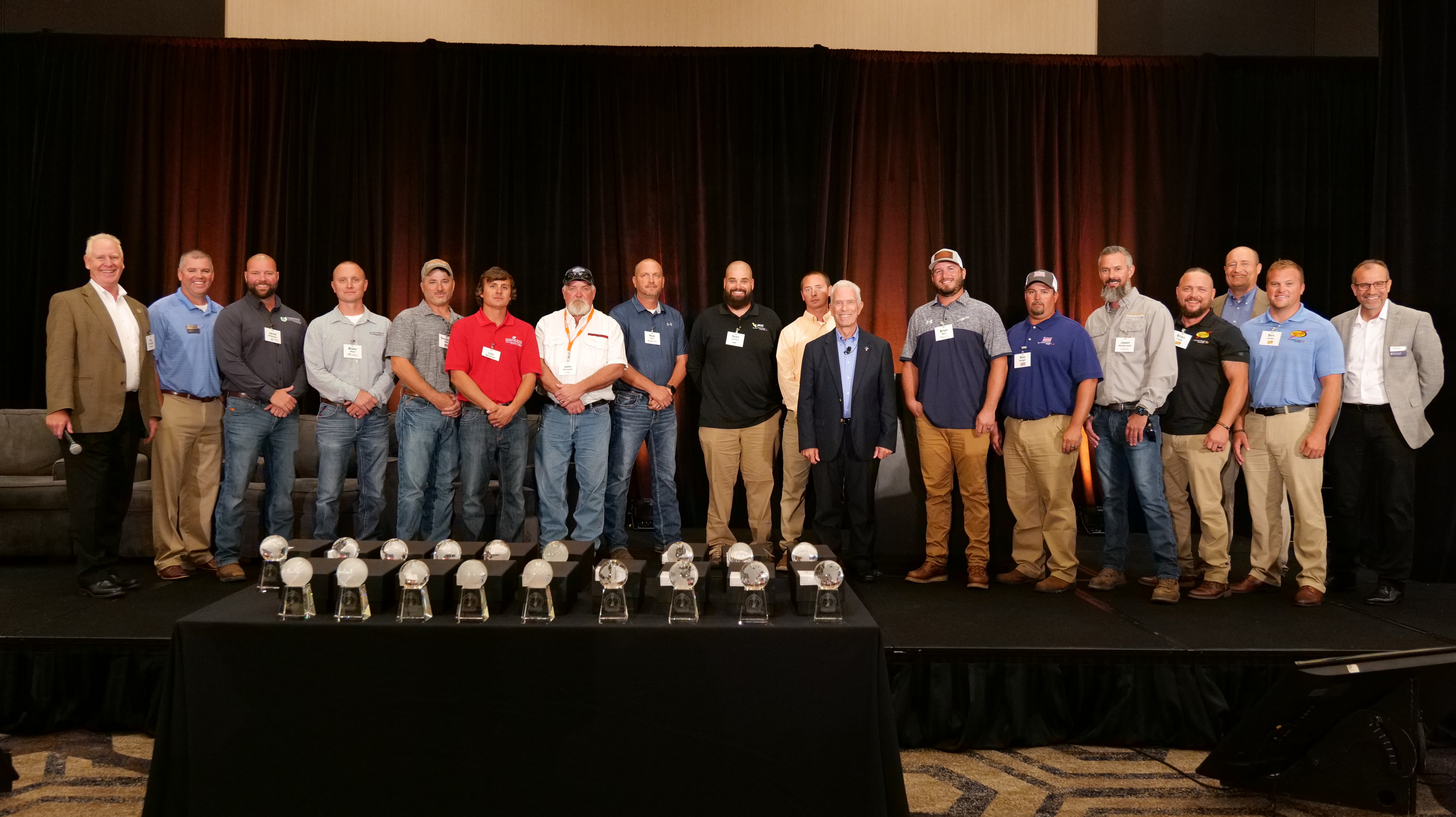 A large group of people posing on a stage
