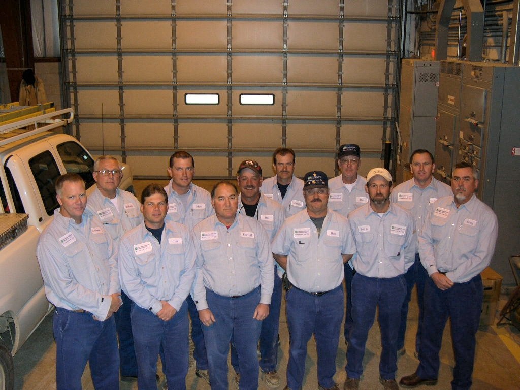A group of men posing inside a garage