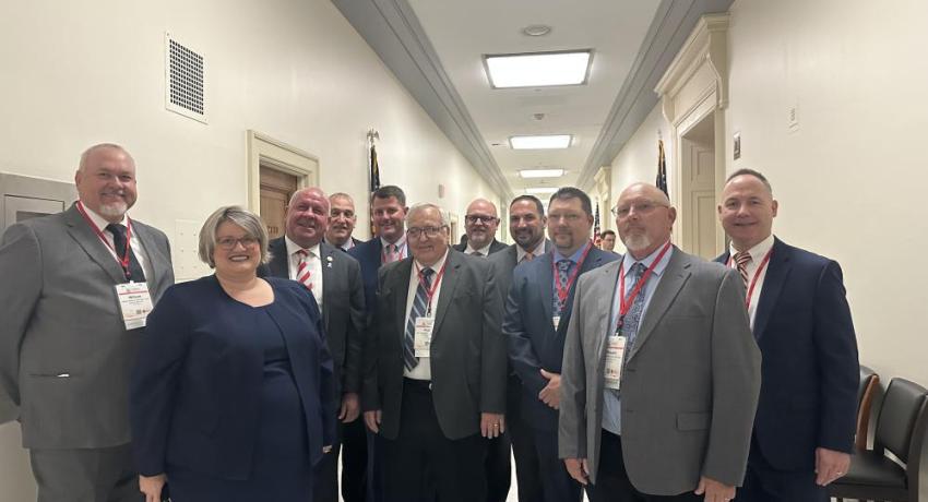 A group of people standing in a legislative building