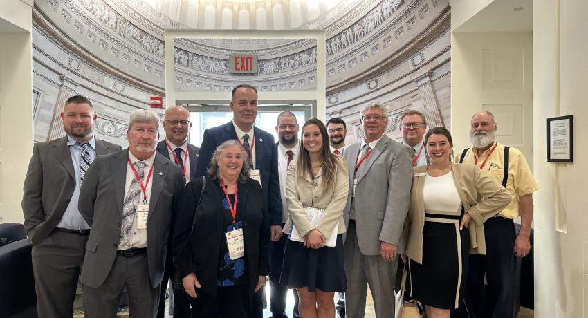 A group of people standing in a legislative building